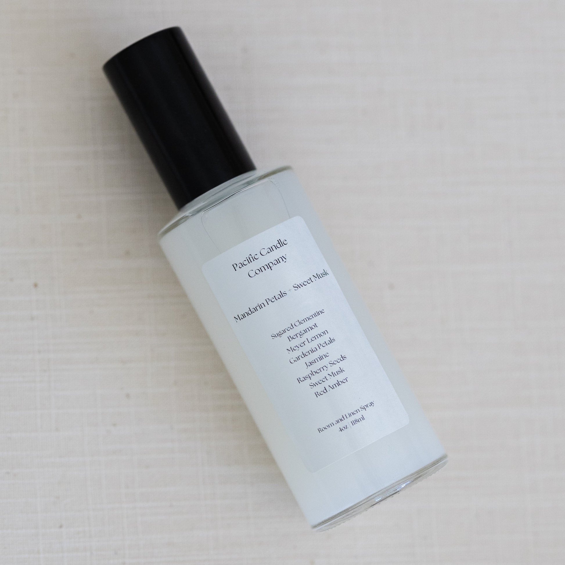 An eco-friendly room spray in a sleek amber glass bottle, made with clean, phthalate-free ingredients to refresh any space with a luxurious scent. Perfect for quickly creating a calming or uplifting atmosphere. Scent: Mandarin Petals + Sweet Musk.