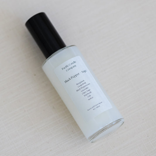 An eco-friendly room spray in a sleek amber glass bottle, made with clean, phthalate-free ingredients to refresh any space with a luxurious scent. Perfect for quickly creating a calming or uplifting atmosphere. Scent: Black Pepper + Sage
