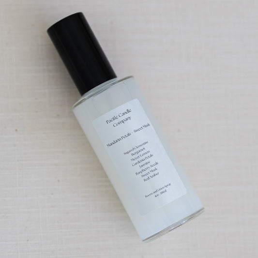 An eco-friendly room spray in a sleek amber glass bottle, made with clean, phthalate-free ingredients to refresh any space with a luxurious scent. Perfect for quickly creating a calming or uplifting atmosphere. Scent: Mandarin Petals + Sweet Musk.