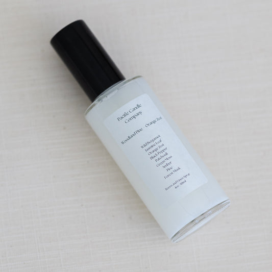 An eco-friendly room spray in a sleek glass bottle, made with clean, phthalate-free ingredients to refresh any space with a luxurious scent. Perfect for quickly creating a calming or uplifting atmosphere. Scent: Woodland Pine + Orange Zest