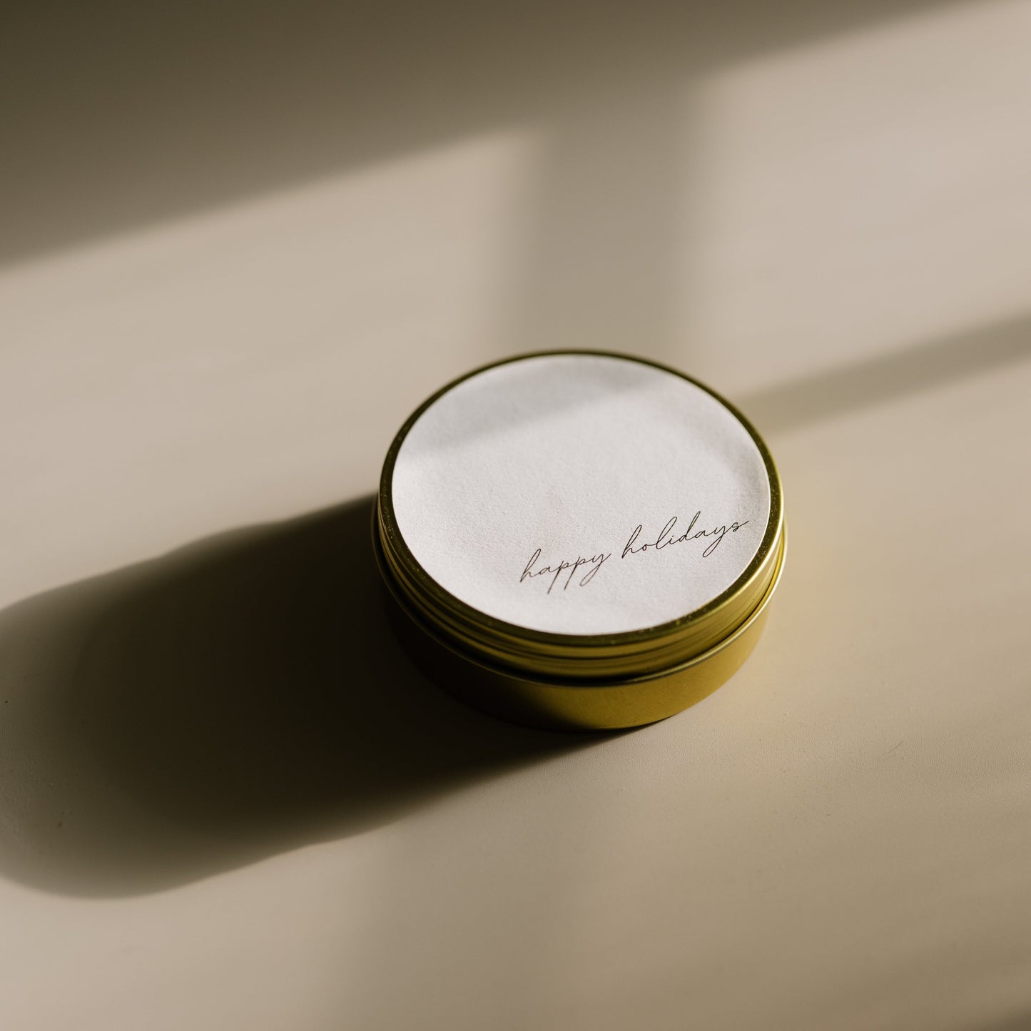 Happy Holidays. A travel-size soy candle in a stylish and reusable tin, hand-poured with clean, eco-friendly wax for on-the-go luxury. Ideal for gifting or bringing a cozy atmosphere to any space.
