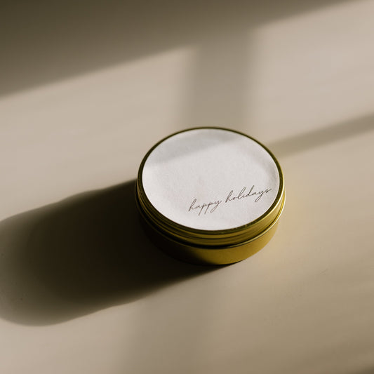 Happy Holidays. A travel-size soy candle in a stylish and reusable tin, hand-poured with clean, eco-friendly wax for on-the-go luxury. Ideal for gifting or bringing a cozy atmosphere to any space.
