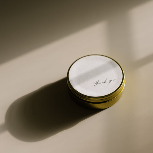 Thank You. A travel-size soy candle in a stylish and reusable tin, hand-poured with clean, eco-friendly wax for on-the-go luxury. Ideal for gifting or bringing a cozy atmosphere to any space.