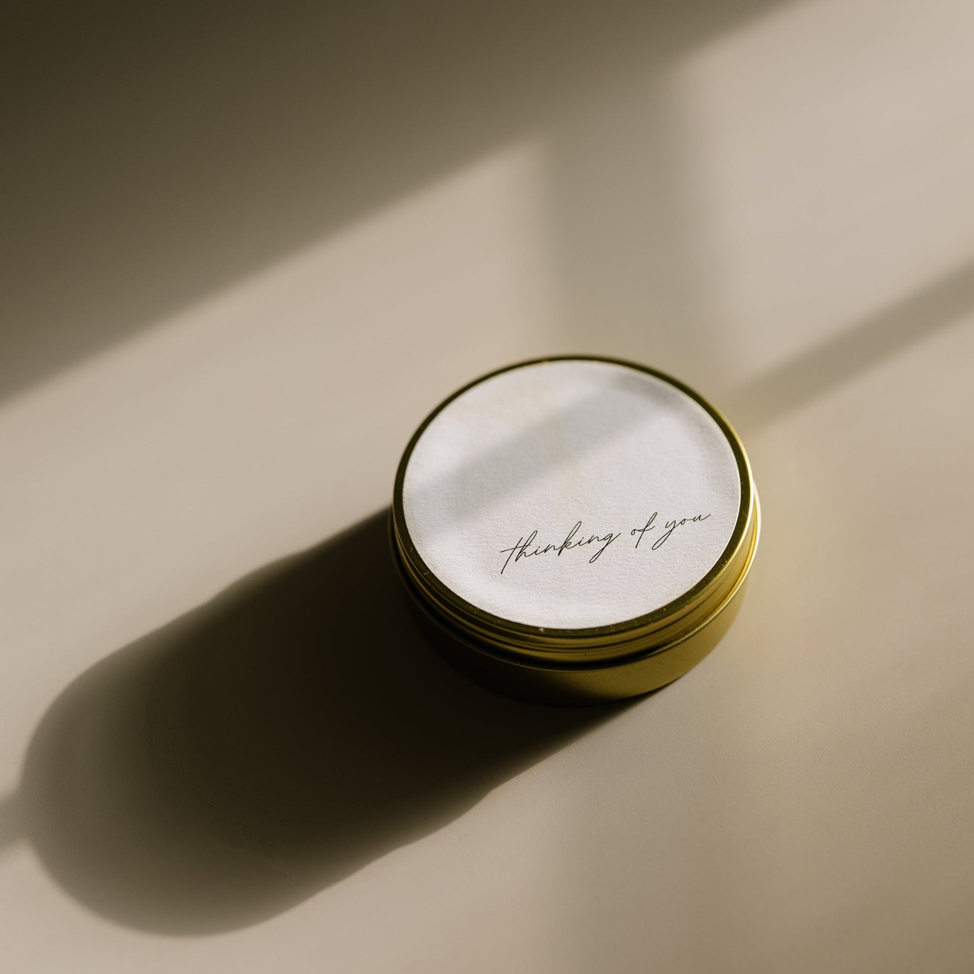 Thinking Of You. A travel-size soy candle in a stylish and reusable tin, hand-poured with clean, eco-friendly wax for on-the-go luxury. Ideal for gifting or bringing a cozy atmosphere to any space.